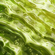 Fondo con detalle y textura de capa de gel de aloe vera con tonos verdes y reflejos de luz
