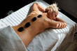 Mid adult woman geting hot stone massage