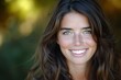 © Adobe Contributor - Portrait of a smiling young woman with long brown hair and green eyes