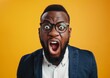 © Qstock - Shocked African American Man with Glasses Over Yellow Background