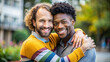 © Yekatseryna - Happy young gay lgbtq couple in love cuddling and smiling together at street. Two stylish diverse pretty man hugging and bonding. LGBT relationship lifestyle concept