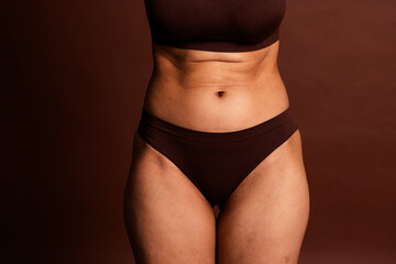 Wall Mural - Cropped photo of plus size lady underwear lingerie enjoying self acceptance isolated brown color background