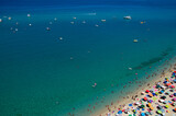 Fototapeta  - Aerial view of sandy beach with swimming people in sea with transparent blue water in summer.