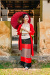 Northern Thai Chiangmai lanna people in traditional style clothes beautiful women old vintage dressing with paper umbrella at wat ton kwen.