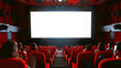 Cinema hall with audience seated in red chairs facing a large blank screen, evoking a movie-watching atmosphere.
