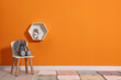 © New Africa - Beautiful children's room with bright orange wall and furniture, space for text. Interior design