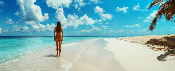 Poster - A woman in a bikini standing on a pristine beach facing turquoise waters under a sunny sky with clouds.