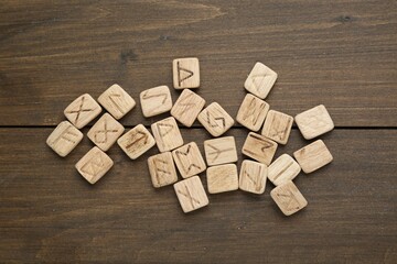 Sticker - Runes with different symbols on wooden table, flat lay