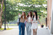 © Natee Meepian - College friends walk to class together. University student in campus talk and have fun outdoors
