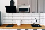 Fototapeta Niebo - White cabinets with wooden counter of modern kitchen. High quality photo