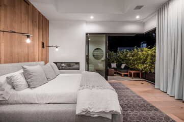 a bedroom with a wooden paneled wall and a large bed in it