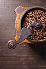 Wall Mural - close-up of old coffee grinder and roasted coffee beans