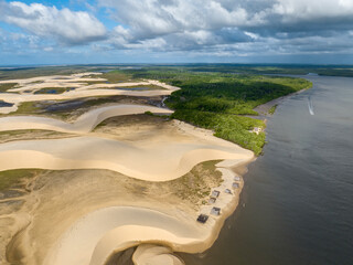 Wall Mural - Aerial view of Parque da Dunas - Ilha das Canarias, Brazil. Huts on the Delta do Parnaíba and Delta das Americas. Lush nature and sand dunes. Boats on the river bank
