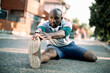 © Geber86 - Active young black man stretching on the street