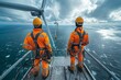© Surachetsh - Technicians conduct surveys and observations beneath a colossal ocean wind turbine by sailing ship and climbing a mountainous, as they carry out maintenance and cleaning tasks.