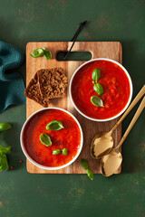 Wall Mural - tomato and bell pepper vegetarian soup on green background