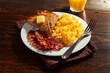 traditional scrambled egg breakfast with bacon and toast