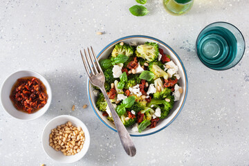 Wall Mural - healthy broccoli salad with feta cheese sun dried tomatoes pine nuts.. vegetarian low carb keto diet