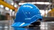 © Anastasiia - Blue safety helmet for construction worker PPE in factory setting for safety. Concept PPE, Safety Helmet, Construction Worker, Factory Setting, Safety