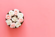 Pink and white rose buds in a wooden vase, top view