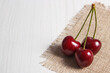 Fresh ripe cherries on jute cloth. Healthy dessert or snack. Place for text