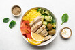 Healthy salad with chicken, tomato, cucumber, olives and rice in bowl on white background with copy space