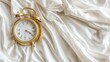© Anzhela - Gold alarm clock on white bed linen close-up, concept of time, banner, empty space for text