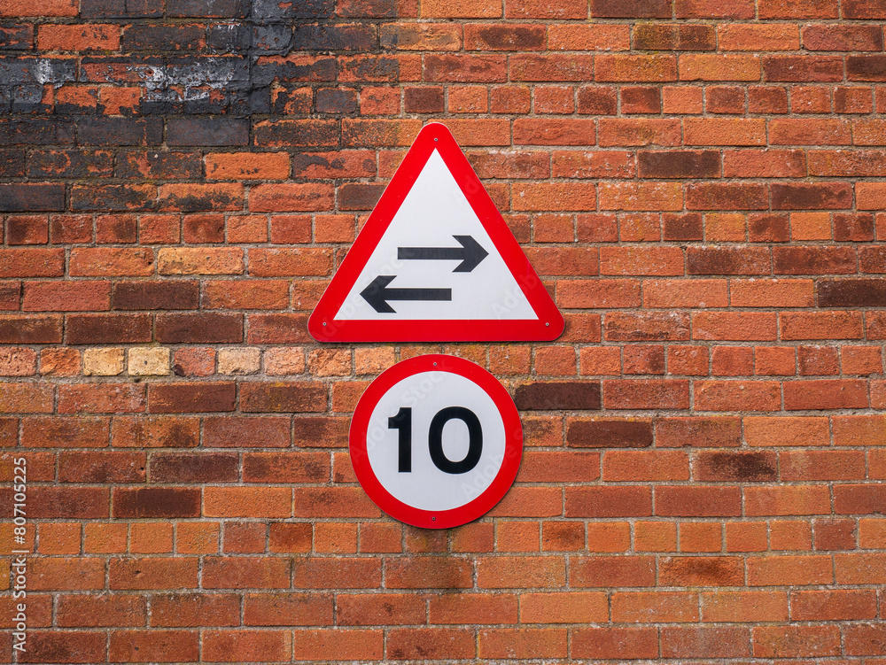 Speed limit sign indicating 10 KPH or MPH with two way direction arrows ...