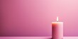 Pink background with white thin wax candle with a small lit flame for funeral grief death dead sad emotion with copy space texture for display 