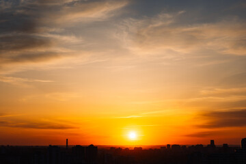 Wall Mural - majestic dusk in tropics. golden sunset sky with beautiful silhouette city buildings in the evening.