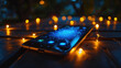 A cell phone rests on a table surrounded by flickering candles, creating a warm and cozy atmosphere