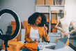 © ARMMY PICCA - Fashion blogger concept, Young Asian women selling clothes on video streaming.Startup small business SME, using smartphone or tablet taking receive and checking in office