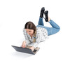 A young girl in a shirt and jeans is lying on her stomach, on the floor and working on a laptop, isolated on a white background. View from above