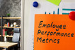 Employee performance metrics. A whiteboard with a chart and sheet attached.