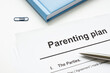 © Vitalii Vodolazskyi - Parenting plan document and pen for signature.
