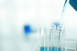 © PIC SNIPE - Medical or scientific researcher or man doctor looking at a test tube of clear solution in a laboratory