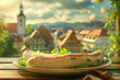 White sausage on a plate on a restaurant table with a Bavarian town in the background