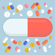 Huge pill surrounded by medicines
