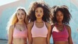 © antkevyv - Body positivity movement, three young women in sportswear standing together and looking at camera, unity friendship teamwork cooperation support