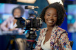© mila103 - A woman with curly hair is sitting in front of a camera