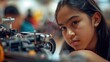 The close up picture of the hispanic girl participating in robotics or mechanic competition, robotics competition require robotics knowledge and skills, focus and concentration, adaptability . AIG43.