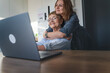 Portrait of young woman teaching senior mother using laptop and internet at home