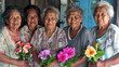 A group of elderly individuals holding colorful tropical flowers, likely from a Pacific Island community, posed in front of a wooden structure.