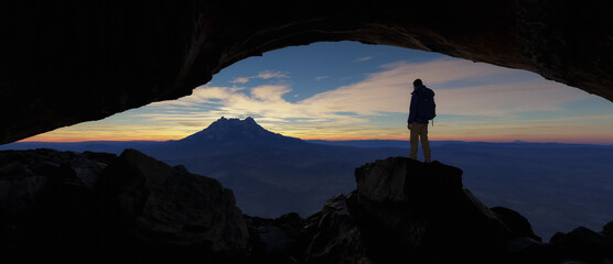 Wall Mural - adult adventurous man standing in a cave. 3d rendering mountain adventure artwork.