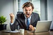 © Alexander - Angry businessman sitting at his desk and screaming.
