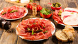 Appetizers with differents antipasti, charcuterie and snacks . Sausage, ham, tapas, olives and crackers for buffet party.