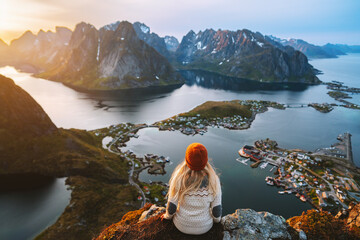 Wall Mural - woman hiking in lofoten islands travel lifestyle in norway, girl enjoying aerial view from reinebrin