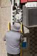 electrician worker install optical fiber cable for internet and telephone  lines  in city street