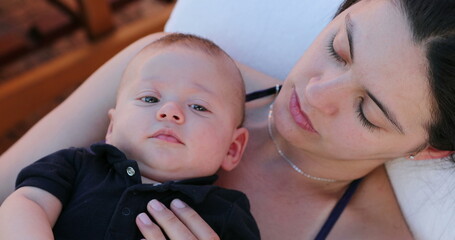 Wall Mural - Mom and infant baby son together outside looking to camera