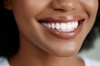 © Balaraw - Close-up of a person's smiling mouth with white teeth